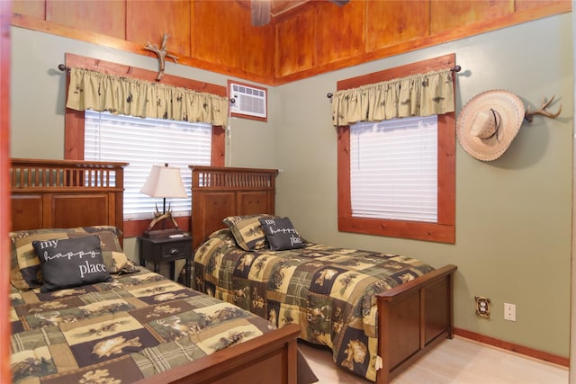 302 Bluebonnet Rd, Sheridan, TX 78950 - bedroom with a wall mounted AC, wood finished floors, and baseboards