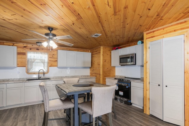 134 Magnolia Point Dr, Houston, TX 77336 - dining room with wood ceiling, dark wood-type flooring, ceiling fan, and wooden walls