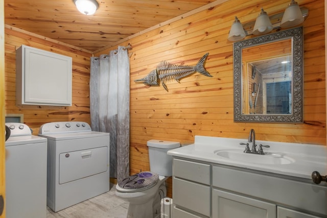 134 Magnolia Point Dr, Houston, TX 77336 - bathroom featuring washing machine and clothes dryer, wood walls, toilet, vanity, and wood ceiling