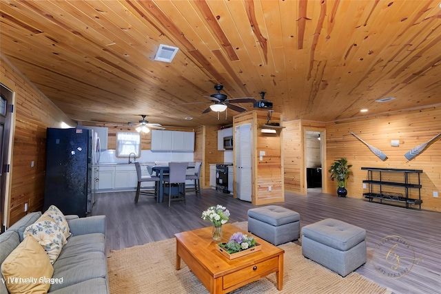 134 Magnolia Point Dr, Houston, TX 77336 - living area with wooden walls, wood ceiling, dark wood-style flooring, and a ceiling fan