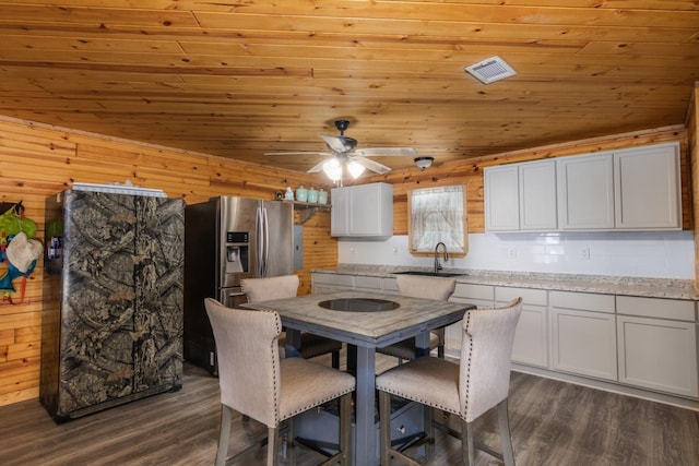 134 Magnolia Point Dr, Houston, TX 77336 - dining space with wood ceiling, dark wood finished floors, ceiling fan, and wood walls