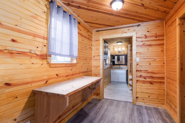 134 Magnolia Point Dr, Houston, TX 77336 - hallway with wood walls, wood ceiling, wood finished floors, and a sink