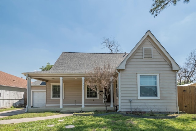 1109 Dismuke St, Houston, TX 77023 - view of front of home featuring covered porch, an attached garage, and a shingled roof