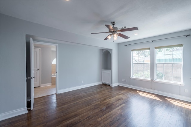 1109 Dismuke St, Houston, TX 77023 - empty room with ceiling fan, wood finished floors, arched walkways, baseboards, and recessed lighting