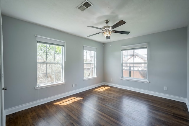 1109 Dismuke St, Houston, TX 77023 - spare room featuring baseboards, dark wood-style floors, and ceiling fan