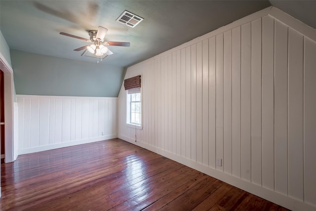 1109 Dismuke St, Houston, TX 77023 - additional living space featuring wood-type flooring, a ceiling fan, a decorative wall, wainscoting, and vaulted ceiling