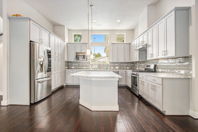 2422 Maufferd, Houston, TX 77009 - kitchen with appliances with stainless steel finishes, light countertops, decorative backsplash, a kitchen island, and recessed lighting