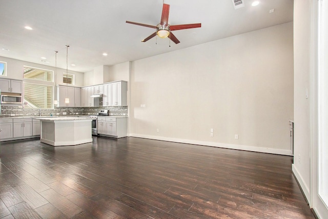2422 Maufferd, Houston, TX 77009 - unfurnished living room with a ceiling fan, dark wood-style flooring, and recessed lighting