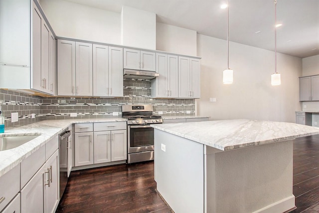 2422 Maufferd, Houston, TX 77009 - kitchen featuring appliances with stainless steel finishes, under cabinet range hood, dark wood finished floors, tasteful backsplash, and recessed lighting