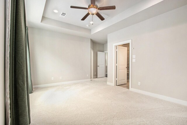 2422 Maufferd, Houston, TX 77009 - empty room with light colored carpet, ceiling fan, a tray ceiling, and recessed lighting