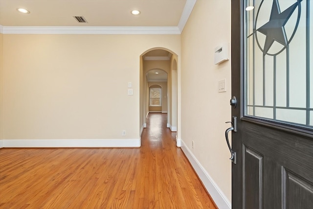 1774 Aden Dr, Houston, TX 77003 - foyer entrance featuring arched walkways, light wood-style floors, baseboards, ornamental molding, and recessed lighting