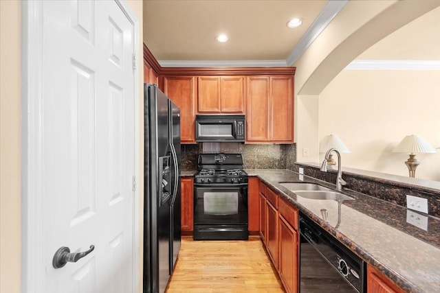 1774 Aden Dr, Houston, TX 77003 - kitchen featuring black appliances, a sink, crown molding, dark stone counters, and backsplash