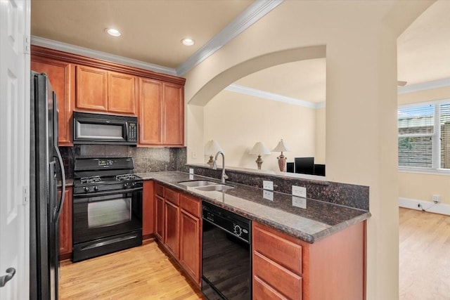 1774 Aden Dr, Houston, TX 77003 - kitchen with black appliances, a sink, crown molding, dark stone countertops, and backsplash