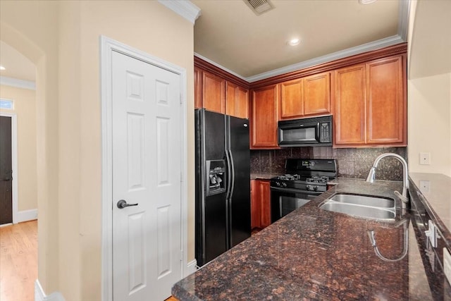 1774 Aden Dr, Houston, TX 77003 - kitchen featuring black appliances, a sink, dark stone countertops, ornamental molding, and decorative backsplash
