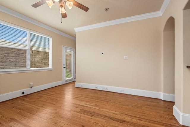1774 Aden Dr, Houston, TX 77003 - unfurnished room with ornamental molding, wood finished floors, ceiling fan, baseboards, and arched walkways