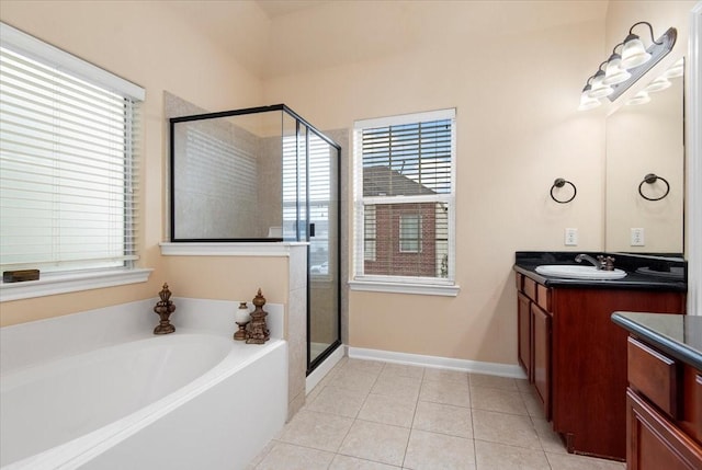 1774 Aden Dr, Houston, TX 77003 - bathroom with vanity, a stall shower, a bath, tile patterned floors, and baseboards