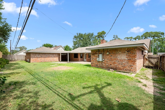 10139 Knoboak Dr, Houston, TX 77080 - back of property featuring brick siding, a patio area, and a chimney