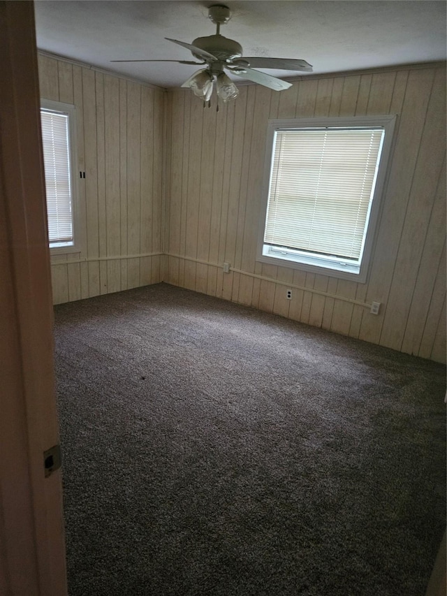 2219 8th St, Galena Park, TX 77547 - spare room with carpet floors, healthy amount of natural light, wood walls, and ceiling fan