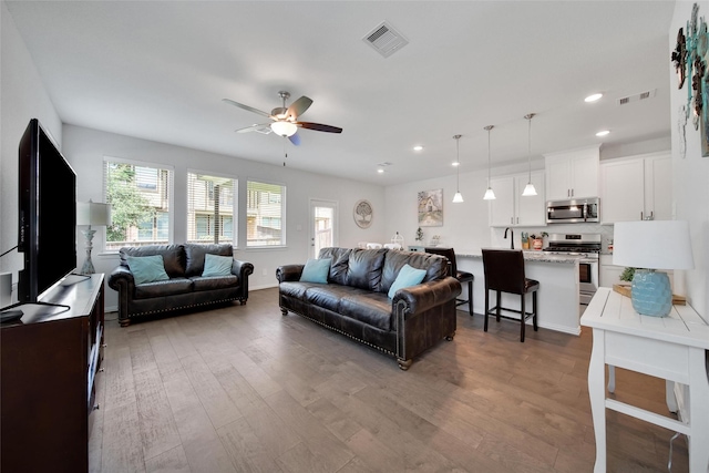 103 Skyshine Ct, Conroe, TX 77304 - living room featuring a ceiling fan, recessed lighting, and wood finished floors