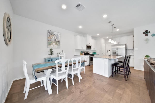 103 Skyshine Ct, Conroe, TX 77304 - dining room featuring light wood-style floors, recessed lighting, and baseboards