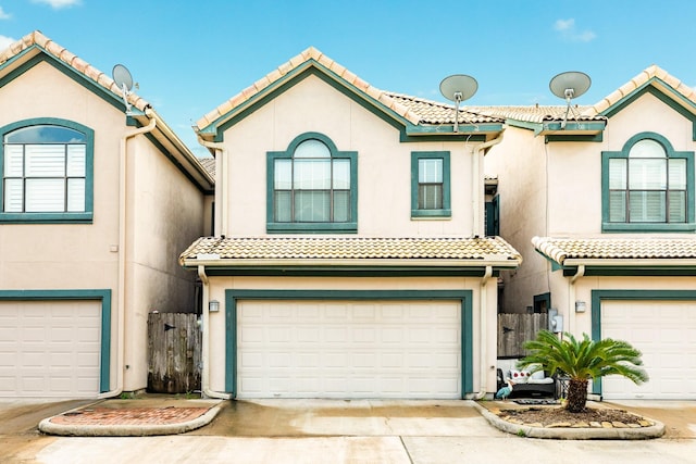 458 Mariners Dr, Kemah, TX 77565 - view of front of home with stucco siding, a tiled roof, an attached garage, and driveway