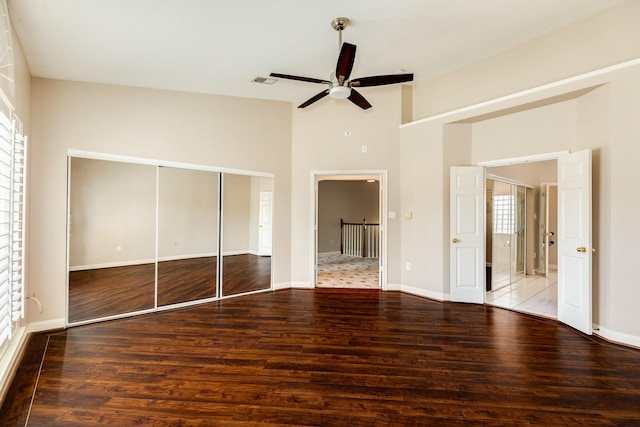 458 Mariners Dr, Kemah, TX 77565 - unfurnished bedroom featuring wood finished floors, baseboards, a closet, high vaulted ceiling, and ceiling fan