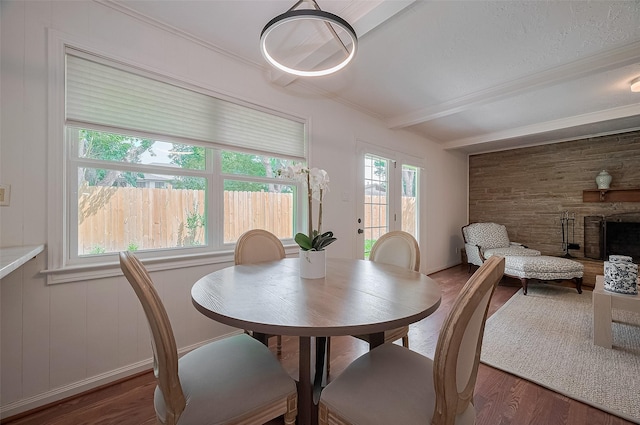 13114 Barryknoll Ln, Houston, TX 77079 - dining area featuring wood finished floors, beam ceiling, a stone fireplace, and ornamental molding