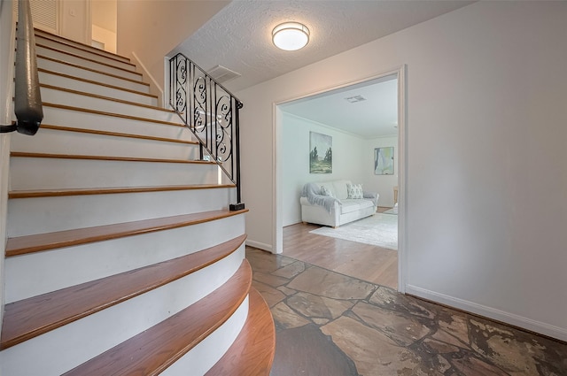 13114 Barryknoll Ln, Houston, TX 77079 - stairway featuring baseboards, wood finished floors, and a textured ceiling