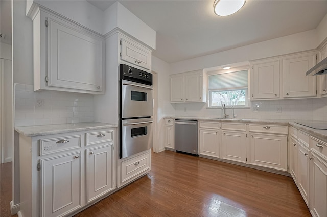 13114 Barryknoll Ln, Houston, TX 77079 - kitchen featuring stainless steel appliances, a sink, and decorative backsplash