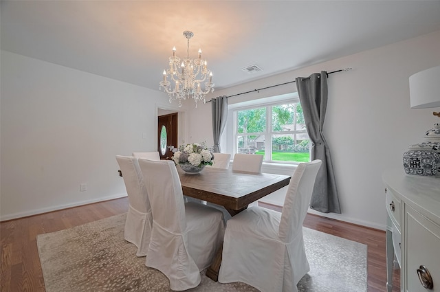 13114 Barryknoll Ln, Houston, TX 77079 - dining space featuring a chandelier, wood finished floors, and baseboards