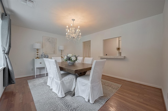 13114 Barryknoll Ln, Houston, TX 77079 - dining area with a chandelier, wood finished floors, and baseboards