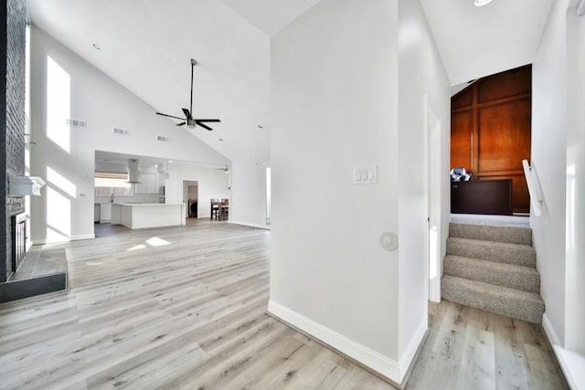 7607 Bankside Dr, Houston, TX 77071 - hallway featuring high vaulted ceiling, light wood-type flooring, stairway, and baseboards