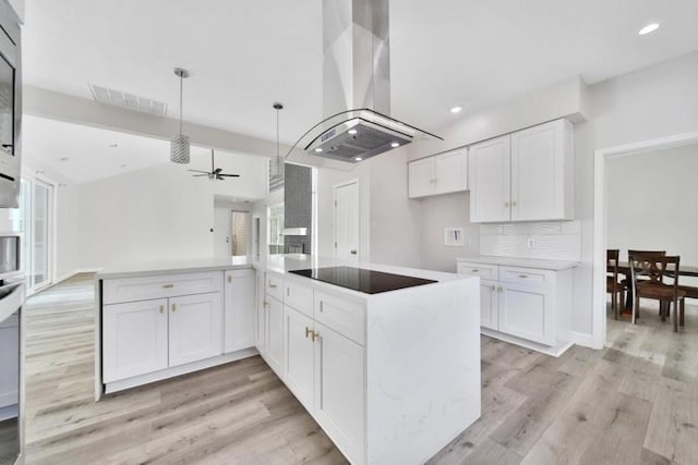 7607 Bankside Dr, Houston, TX 77071 - kitchen with island range hood, light wood-style flooring, ceiling fan, black electric cooktop, and white cabinets