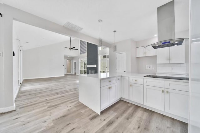 7607 Bankside Dr, Houston, TX 77071 - kitchen featuring island exhaust hood, light wood finished floors, white cabinetry, and ceiling fan