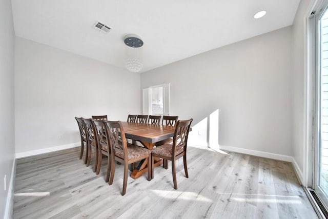7607 Bankside Dr, Houston, TX 77071 - dining area featuring wood finished floors, plenty of natural light, baseboards, and a chandelier