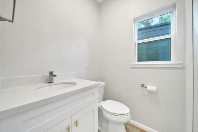 7607 Bankside Dr, Houston, TX 77071 - bathroom with toilet, vanity, baseboards, and wood finished floors
