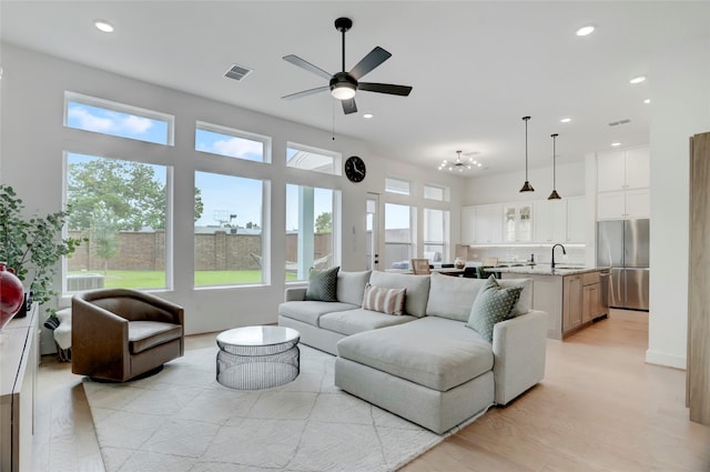 3124 Somerset Levens Ln, Houston, TX 77055 - living room with a ceiling fan, recessed lighting, light wood-style floors, and a chandelier