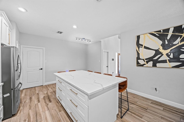 5702 W Vistaglen Loop, Houston, TX 77084 - kitchen featuring stainless steel fridge, a kitchen island, light wood-style flooring, baseboards, and recessed lighting