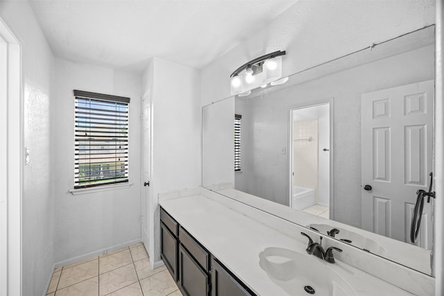 5702 W Vistaglen Loop, Houston, TX 77084 - full bath with vanity, marble look tiles, and baseboards
