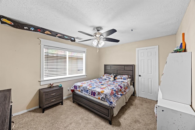 5702 W Vistaglen Loop, Houston, TX 77084 - bedroom featuring light carpet, a textured ceiling, baseboards, and a ceiling fan