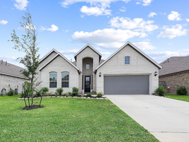 18925 Lazzaro Springs Dr, New Caney, TX 77357 - french country style house with brick siding, concrete driveway, a front yard, and an attached garage