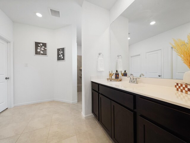 18925 Lazzaro Springs Dr, New Caney, TX 77357 - bathroom featuring vanity, a walk in shower, tile patterned floors, recessed lighting, and baseboards