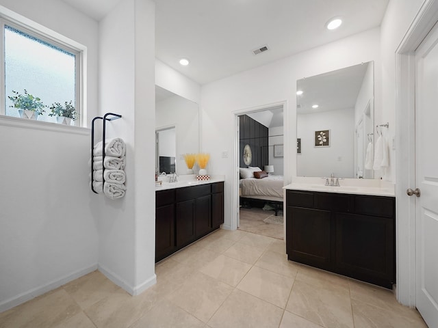 18925 Lazzaro Springs Dr, New Caney, TX 77357 - ensuite bathroom featuring two vanities, tile patterned flooring, recessed lighting, and baseboards
