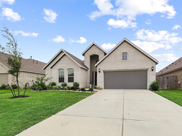 18925 Lazzaro Springs Dr, New Caney, TX 77357 - french country home with brick siding, concrete driveway, and a garage