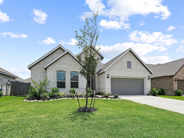 18925 Lazzaro Springs Dr, New Caney, TX 77357 - french country inspired facade featuring brick siding, driveway, and an attached garage