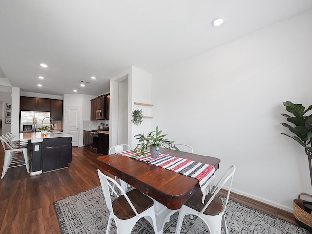 18925 Lazzaro Springs Dr, New Caney, TX 77357 - dining space featuring dark wood finished floors, recessed lighting, and baseboards