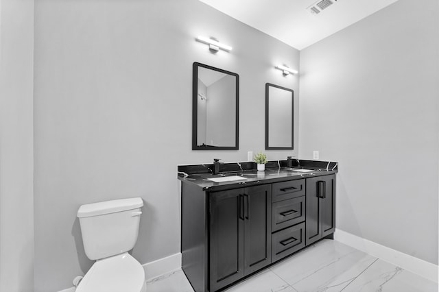 7926 Tate St, Houston, TX 77028 - bathroom featuring baseboards, toilet, marble look tile flooring, and double vanity
