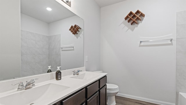 22002 Sovereign Heights Ln, Houston, TX 77073 - bathroom featuring toilet, double vanity, wood finished floors, and a tub to relax in