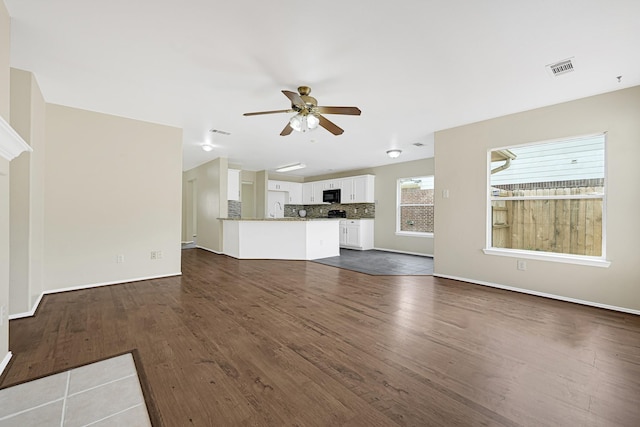 4814 Winding Timbers Ct, Humble, TX 77346 - unfurnished living room featuring a sink, dark wood-style flooring, a ceiling fan, and baseboards