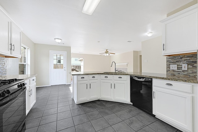 4814 Winding Timbers Ct, Humble, TX 77346 - kitchen featuring black appliances, tasteful backsplash, a peninsula, and dark tile patterned floors
